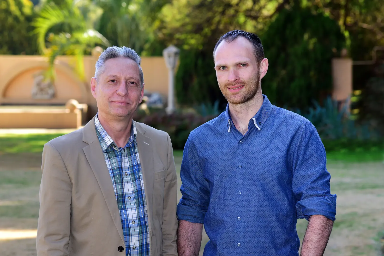 Ryan with Jovan, the owner of a coaching business, standing in a garden.